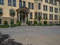 large yellow building with some plants and bushes in front of it for decoration or entertainment