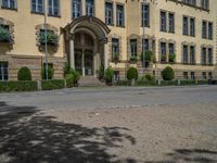 large yellow building with some plants and bushes in front of it for decoration or entertainment