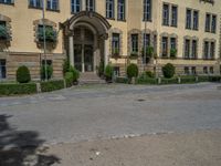 large yellow building with some plants and bushes in front of it for decoration or entertainment