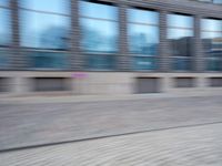a man that is standing next to a skateboard in a street by some buildings