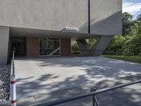 the entrance to an office building with no windows in it, and no stairs on the ground