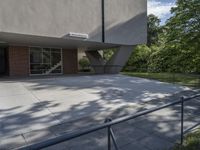 the entrance to an office building with no windows in it, and no stairs on the ground