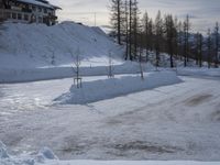there is a person riding their skis down the road in the snow in a wintery area