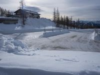 there is a person riding their skis down the road in the snow in a wintery area