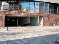 the large building is made of concrete and has metal railings around it, which are made of brick