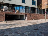 the large building is made of concrete and has metal railings around it, which are made of brick