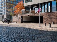 the large building is made of concrete and has metal railings around it, which are made of brick