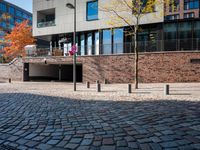 the large building is made of concrete and has metal railings around it, which are made of brick