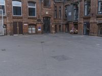 a man sitting in front of an empty building with an outside seating area next to it