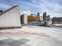 the walkway is empty of any visitors to view the city's buildings and the sidewalk