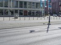 an empty street in front of a store called big b on the corner of a road