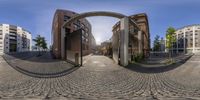 this is a 360 - effect image of the outside of a building where the arch, street and sky are in various directions