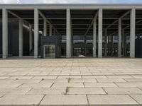 empty building with a concrete floor and pillars with some steps in front of it and a stair leading up to the back