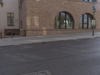 a car parked along the side of a building next to a sidewalk and water fountain