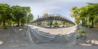 this is a panorama from an angle of the pedestrian walkway on this street, looking out towards a street