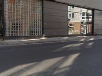 a woman is riding her bike on the street with a helmet strapped to her arm