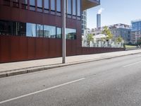 an empty city street with buildings and a truck on the side of it next to rocks