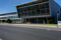 an empty street and an office building in the distance on a clear day in europe