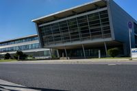 an empty street and an office building in the distance on a clear day in europe