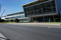 an empty street and an office building in the distance on a clear day in europe