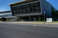 an empty street and an office building in the distance on a clear day in europe