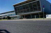 an empty street and an office building in the distance on a clear day in europe