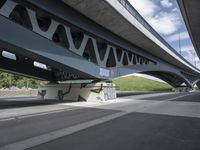 a bike is riding under a bridge over a road with graffiti and a person in a wet suit