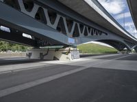 a bike is riding under a bridge over a road with graffiti and a person in a wet suit