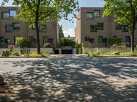 the back side of this apartment is vacant with the grass around it and trees outside