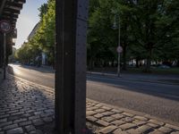 a street that has no traffic sign on it and some trees in the back ground