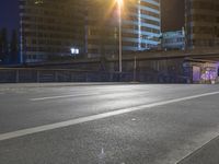 a street at night with many cars passing under the bridge and on the road there is long exposure on camera