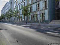 a manhole cover in the middle of a street with the reflection of a building in the glass of it