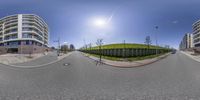 a fish - eye lens shot of a street with a view of a hill with a ramp