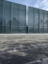 an empty courtyard with an exitway in front of it and some sky in the background