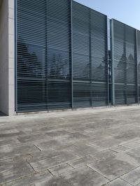 an empty courtyard with an exitway in front of it and some sky in the background