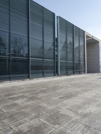 an empty courtyard with an exitway in front of it and some sky in the background