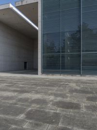 an empty courtyard with an exitway in front of it and some sky in the background