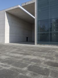 an empty courtyard with an exitway in front of it and some sky in the background