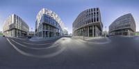 the three buildings are near each other on the street in front of them are curved shapes