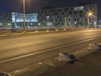 there are many pieces of furniture lying on the side of a road by itself with some streetlights