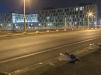 there are many pieces of furniture lying on the side of a road by itself with some streetlights