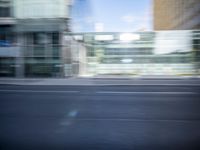 this is a photograph of a building from the street with blurry in it and with traffic going by