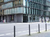 an empty street with tall glass buildings in the background of this photo in europe,