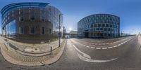 the three circular objects are clearly seen from the street in this fish eye shot of an intersection