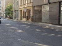 a person riding down the road near a parked car, with no traffic visible in the way