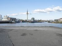 there is a water way that is next to the harbor and buildings are in the background