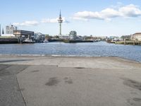 there is a water way that is next to the harbor and buildings are in the background