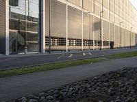 the side of a building is adorned with perforable glass and features large window sivers