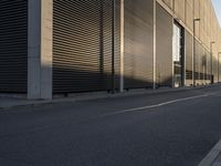 this is an empty, deserted street with dark buildings in the background and a red fire hydrant on either side