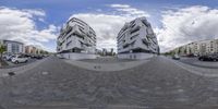 the image shows an upside down photo of two modern buildings, including one larger and one smaller